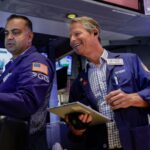 Nasdaq rises to new record; S&P 500 closes flat as oil slides for a fifth day